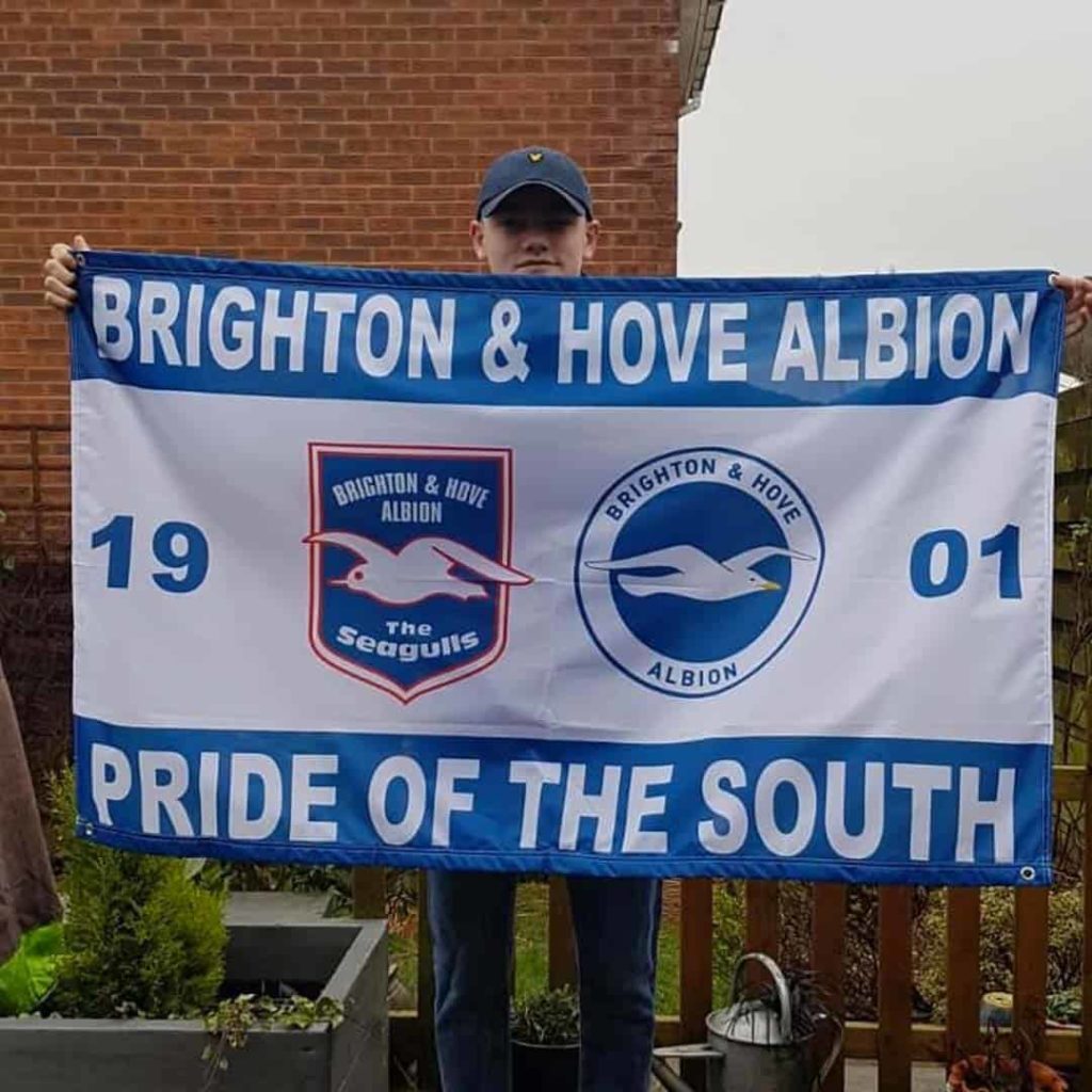 A lad holding Brighton & Hove flag designed on Ultras Design website